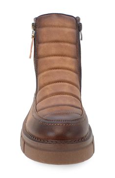 a brown boot with zippers on the side