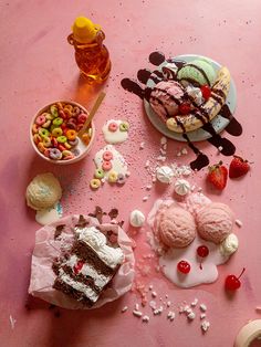 a pink table topped with lots of different desserts