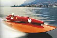 a man driving a red speed boat in the water