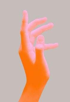 a person's hand in the air with their fingers extended up to show an orange light