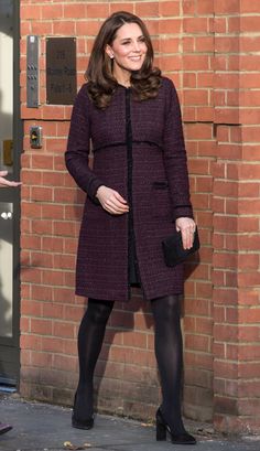 the duke and princess of cambridge are all smiles as they stand in front of a brick wall