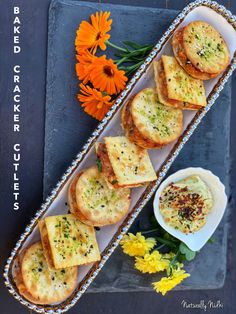 some food is sitting on a tray next to flowers