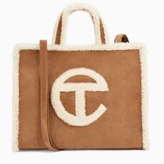 Ugg X Telfar Large Suede / Shearling Trim Limited Edition Tote With Dust Bag Product Details: Genuine Leather Cowhide Suede And Shearling Sheepskin Trim Handle: 5" Drop Strap: 20.5" Drop Dimension: 19" (W) X 15" (H) X 5.5" (D) Comes With Dust Bag Telfar Bags, Ugg Bag, Western Outfits Men, Suede Tote Bag, Suede Tote, Lock Up, Shopper Tote, Shopper Bag, Everyday Bag