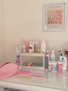 a white table topped with lots of cosmetics and personal care items on top of it