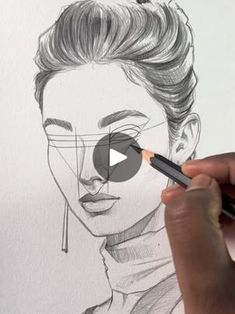 a person drawing a woman's face with a pencil