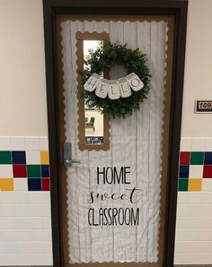 a door decorated with the words home sweet classroom and a wreath hanging on it's front door