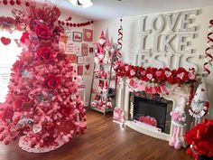 a valentine's day tree decorated with red and pink flowers in a living room