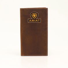 Measures: 6-1/2 x 3-1/2 Distressed Rodeo Style Ariat Logo Ribbon Inlay Multiple Card Slots Cash Compartment Removable Photo Slip Clear ID Window Stay both organized and in style with this Ariat rodeo wallet by M&F Western Products. Medium brown leather with Ariat shield and text logo on ribbon inlay. Features multiple compartments for your credit cards, cash and ID. Ariat Logo, Rodeo Style, Ribbon Logo, Western Boots For Men, Rodeo Fashion, Boot Jewelry, Work Boots Men, Text Logo, Medium Brown