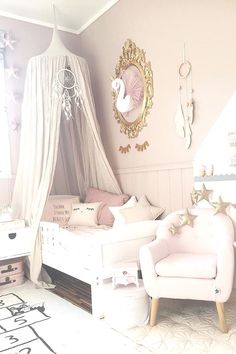 a bedroom with a canopy bed and white furniture