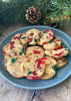 christmas cookies on a blue plate with pine cones in the background and text overlay