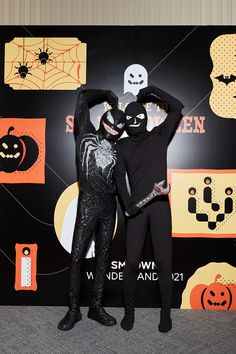 two people dressed up in halloween costumes posing for the camera with their arms around each other