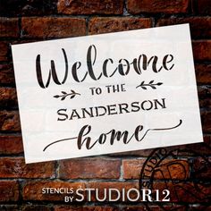 a sign that reads welcome to the sanders home on a brick wall with an iron wheel