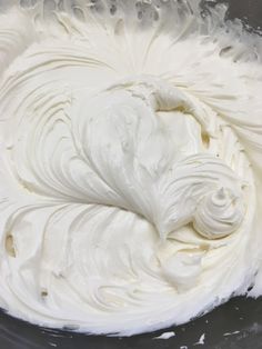 whipped cream in a glass bowl on top of a table