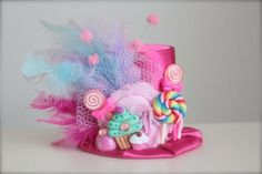 a pink hat with candy and candies on it