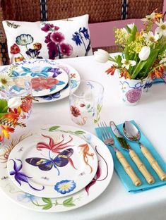 the table is set with colorful plates and silverware