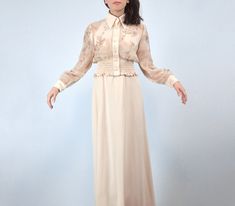 Keep cool and collected in this classic vintage 1970s cream maxi dress with a sheer floral print matching jacket.  ✈ Features ✈ J a c k e t . . . * Collared neckline * 7 faux pearl buttons  * Sheer floral print body w/ rhinestone detailing * Solid cuffs w/ 2 faux pearl buttons (non-working) & hidden metal snaps * Wide elasticized ruched bottom hem D r e s s . . . * Short standup collar * Empire waistline * A-line lower ✈ Specifics ✈ Label: -- Tagged Size: -- Approx. Fit: Extra Small to Small Col Vintage Maxi Dress For Dress Down In Spring, Elegant Spring Maxi Dress For Vintage Fashion, Spring Formal Retro Maxi Dress, Spring Retro Formal Maxi Dress, Spring Vintage Style Maxi Dress, Vintage Spring Maxi Dress For Weddings, Vintage Style Maxi Dress For Spring Wedding, Vintage Spring Wedding Maxi Dress, Vintage Beige Maxi Dress For Daywear