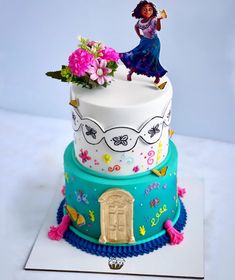 a three tiered cake decorated with flowers and an image of a woman on top