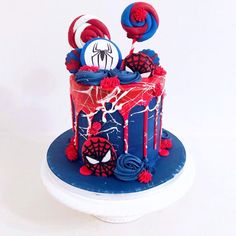 a spiderman birthday cake with red, white and blue decorations