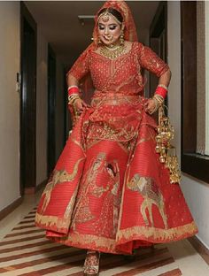 a woman in a red and gold bridal gown