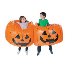 two children sitting in pumpkin shaped beds with jack - o'- lanterns on them