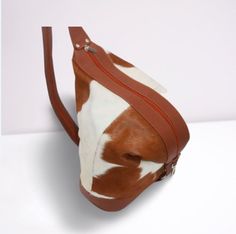 All our calf hair shoulder bags are free shipping Worldwide. Size: 12 x 14 Inches Custom-made to order of its kind real cowhide shoulder bag. A perfect blend of cowhide with leather details on these cowhide shoulder purses. Black-spotted cowhide over white hair gives this purse an amazing look and look stunning. FEATURES: 1- Made from Genuine Cowhide Leather. 2- Natural Cow hair/ Calf Hair. 3- Ladies purse. 4- Made from high quality leather. 5- Size: 12 x 14 We also make cowhide camera bags are Purses Black, Bucket Backpack, Shoulder Purses, Backpack Gift, Backpack Style, Cow Skin, Ladies Purse, Camera Bags, Bag Makeup