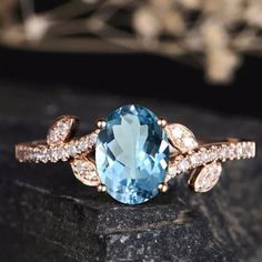 an oval blue topazte and diamond ring on a rock