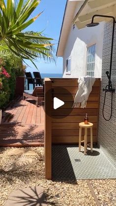 an outdoor shower with a wooden bench next to it