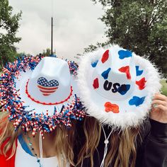 two girls wearing patriotic hats with the word usa painted on them and red, white, and blue decorations