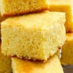 several pieces of yellow cake sitting on top of a plate with one piece cut out