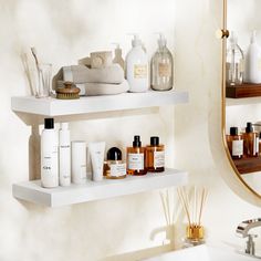 two white shelves filled with different types of personal care items next to a bathroom sink