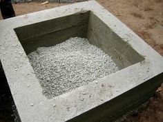 a cement block with gravel in it and a person standing next to it on the ground