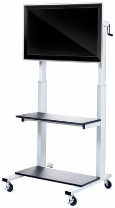 a flat screen tv sitting on top of a metal stand next to a white wall