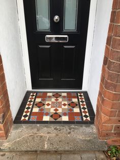 the front door is decorated with colorful tiles