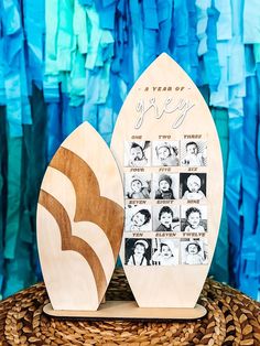 two wooden surfboards sitting on top of a wicker basket next to a blue wall