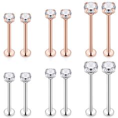 six pairs of surgical piercings with crystal stones on each side and two different sizes