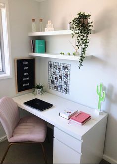 a white desk topped with a laptop computer and a pink chair next to a window