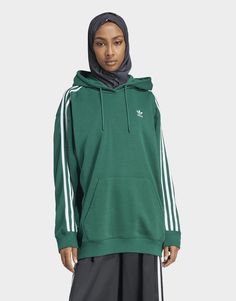 Cosy up in this oversized hoodie, inspired by adidas' roots in sport. Made with soft French terry cotton, it's designed with ribbed cuffs to keep sleeves in place. The loose shape creates a relaxed look perfect for lounging or pairing with leggings for errands around town. With a nod to adidas heritage, the iconic 3-Stripes remind you of the brand's legacy as an innovator. The cotton in this product has been sourced through Better Cotton. Better Cotton is sourced via a chain of custody model called mass balance. This means that Better Cotton is not physically traceable to end products.Find out more here: https://bettercotton.org/who-adidas-are/our-logo/• This model is 176 cm and wears a size 36. Their chest measures 76 cm and the waist 60 cm.• Loose fit• Drawcord-adjustable hood• 70% cotto Green Adidas, Model Call, Adidas Hoodie, Oversized Hoodie, Jd Sports, Culture Kings, Cotton Fleece, Oversize Hoodie, Green Fashion