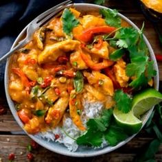 a bowl filled with chicken and rice topped with cilantro