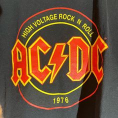 Band: acdc  Size:  18" pit to pit  &      15" collar to bottom  Colors: black Condition: excellent  **all of our shirts are PRE-OWNED and may contain normal wear, fading, stains or imperfections, holes, tears, loose or missing threads. We will do our best to point out significant issues. Thank you for looking!! #tshirt #fashion #tshirtdesign #tshirts #style Retro Black Top With Band Logo, Black Band Logo Top For Music Festivals, Black Grunge Tops For Music Festivals, Black Grunge Top For Music Festivals, Rock Style Logo Print Crew Neck Top, Rock Style Logo Print Tops For Concert, Rock Style Crew Neck Top With Logo Print, Black Rock Style Top With Text Print, Rock Style Letter Print Tops As Fan Merchandise