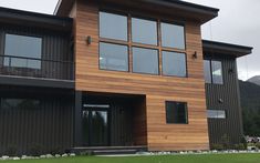 a large brown house with lots of windows