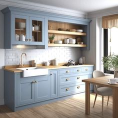 a kitchen with blue cabinets and wooden floors