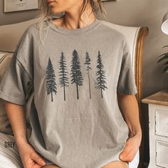 The softest forest evergreen tree tshirt. This beautiful pine tree shirts is printed on the comfiest comfort colors shirt and is sure to make the perfect gift for camping and outdoors lovers! MATERIAL ✨ Shirt sizes are Unisex, please refer to sizing chart in listing photos ✨ 100% ring-spun cotton ✨ Medium fabric weight ✨Relaxed fit ✨Sewn-in twill label CARE ✨ Machine wash: warm (max 40C or 105F) ✨ Do not iron ABOUT My love for design and clothing is what inspired the creation of this store.  Dur Sycamore Gap, Tree Tshirt, Camping Tee, Wardrobe Makeover, Country Stuff, Tshirt Printing Design, Trees Forest, Star Stable, Hiking Shirt