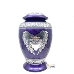 a purple urn with an angel wings design on the front and sides, sitting against a white background