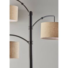 a lamp with three lamps on it and one light hanging off the side of the lamp