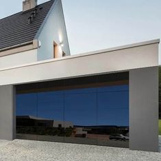 an image of a modern house with glass garage doors