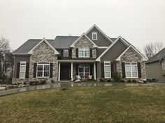 a house with brown siding and white windows