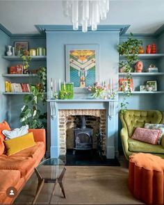 a living room with two couches and a fire place in the middle of it