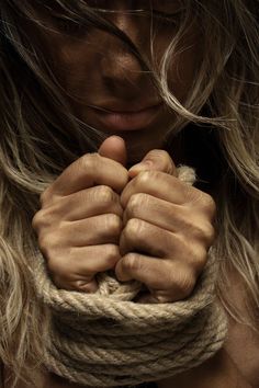 a woman with her hands wrapped around the rope