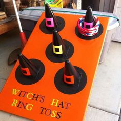 an orange sign that says witch hat ring toss on top of some sort of cones