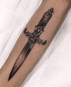 a knife tattoo on the arm